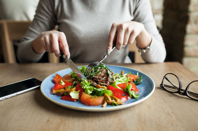 woman eating salad - Portable Food Warmer